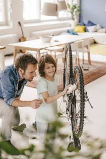 Father and son repairing bicycle together at home model released Symbolfoto property released  KNSF03586
