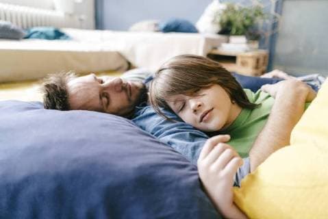 Father and son sleeping at home model released Symbolfoto property released  KNSF03626