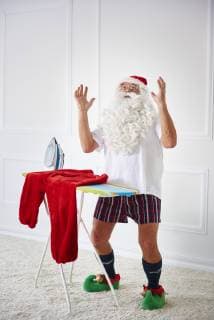 Santa claus with iron board and flat iron model released Symbolfoto  ABIF00116