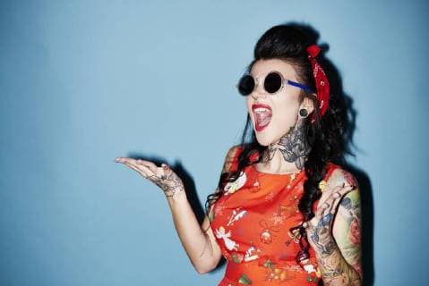 Portrait of tattooed woman against blue background model released Symbolfoto  ABIF00143