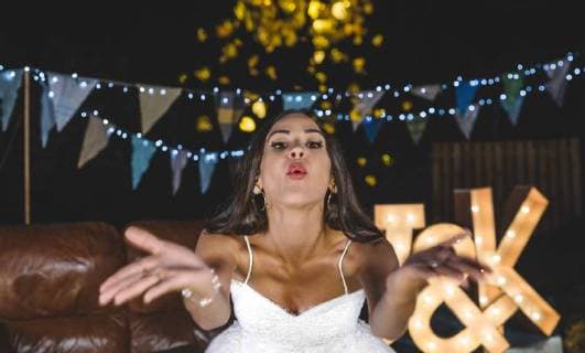 Portrait of happy bride blowing confetti on a night party outdoors model released Symbolfoto property released  DAPF00953