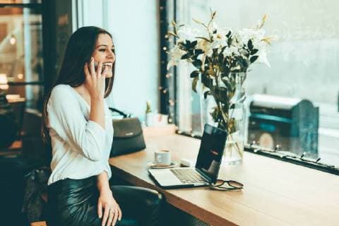 Happy young businesswoman on the phone in a coffee shop model released Symbolfoto property released  OCAF00161