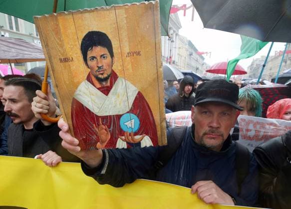 ST PETERSBURG, RUSSIA - MAY 1, 2018: An icon of Telegram founder Pavel Durov held by a participant in a May Day monstration, an annual youth performance art rally, marking International Workers Day on Nevsky Prospekt Street in St Petersburg. Peter Kovalev TASS  TS07DC77