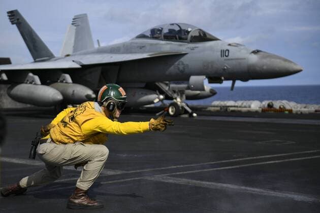 May 2, 2018 - Pacific Ocean - Lt. ADAM HALL signals for an F A-18F Super Hornet assigned to the Fighting Redcocks of Strike Fighter Attack Squadron (VFA) 22 to launch on the flight deck of the aircraft carrier USS Theodore Roosevelt (CVN 71). Theodore Roosevelt is currently deployed in the Pacific Ocean. Pacific Ocean - ZUMAz03_ 20180502_sha_z03_325 Copyright: xUSxNAvyx
