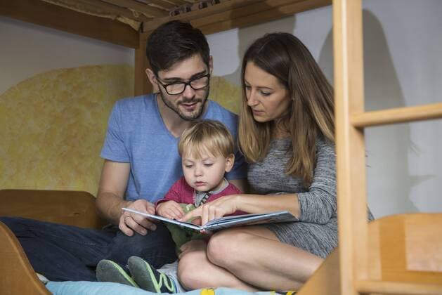Parents reading a book to their son on the bunkbed, Munich, Germany mit_2032_11451