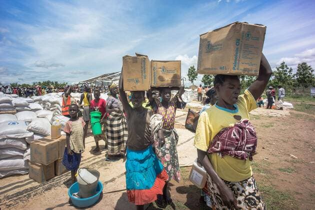 May 7, 2018 - Bidi Bidi, Uganda - South Sudanese female refugees seen carrying palm oil on top of their heads as they were given these food supply by the world food program..The Bidi Bidi refugee settlement in northern Uganda near the South Sudanese border is currently the largest refugee camp in the world, hosting over 250,000 South Sudanese refugees fleeing the conflict. The world food program is providing monthly basic food supply for the refugees in the settlement. Bidi Bidi Uganda - ZUMAs197 20180507_zab_s197_011 Copyright: xGeovienxSox