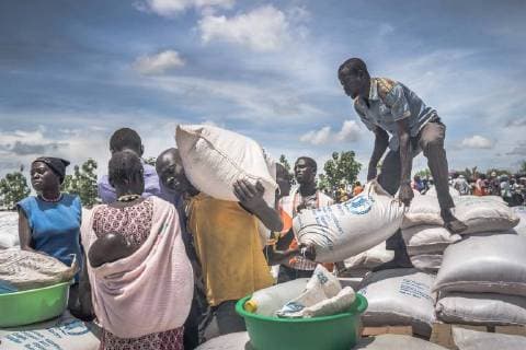 May 7, 2018 - Bidi Bidi, Uganda - South Sudanese refugees seen collecting cassava flour provided by the World Food Program at the refugee settlement..The Bidi Bidi refugee settlement in northern Uganda near the South Sudanese border is currently the largest refugee camp in the world, hosting over 250,000 South Sudanese refugees fleeing the conflict. The world food program is providing monthly basic food supply for the refugees in the settlement. Bidi Bidi Uganda - ZUMAs197 20180507_zab_s197_006 Copyright: xGeovienxSox