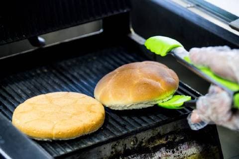 MOSCOW, RUSSIA â€“ MAY 17, 2018: Making a burger with a football bun at a Gazprom Neft filling station. Sergei Bobylev TASS  TS0801D9
