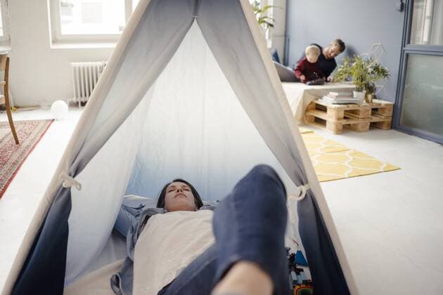 Woman resting in tent , while father is playing with their son in background model released Symbolfoto property released  KNSF03772