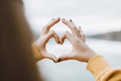Young girl making a heart shape with her fingers model released Symbolfoto  OCAF00203