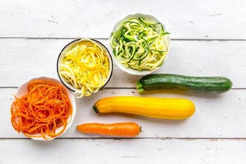 Zoodles, green and yellow zucchini, carrot on white wood  SARF03675