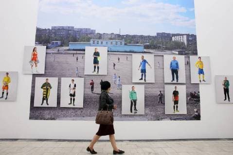 MOSCOW, RUSSIA - JUNE 1, 2018: A girl views an exhibition on the 1897-2018 history of Russian football at the VDNKh exhibition centre. The exhibition covers the history of Russian and Soviet football from the first football team in the Russian Empire (1897) up to the present times. Alexander Shcherbak TASS  TS0822D0