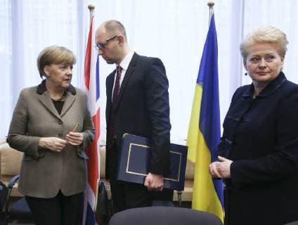 - BRUSSELS, BELGIUM: German Chancellor Angela Merkel, Ukrainian Prime Minister Arseniy Yatsenyuk and Lithuania s President Dalia Grybauskaite pictured during the signature of an agreement with Ukraine on the second day of the EU summit of heads of state and government, at the EU headquarters in Brussels, Friday 21 March 2014. POOLxOLIVIERxHOSLET  x56305644x