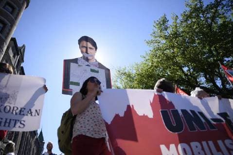 June 9, 2018 - Quebec City, Ontario, Canada - Protesters with a cut out of Justin Trudeau during a rally to protest the G7 summit in Quebec City, Canada on 9 June 2018. During the last day of the G7 summit that is happening in La Malbaie, Quebec, protesters came on to the streets to protest the summit in Quebec City. Quebec City Canada  - ZUMAn230 20180609_zaa_n230_1060 Copyright: xArindamxShivaanix