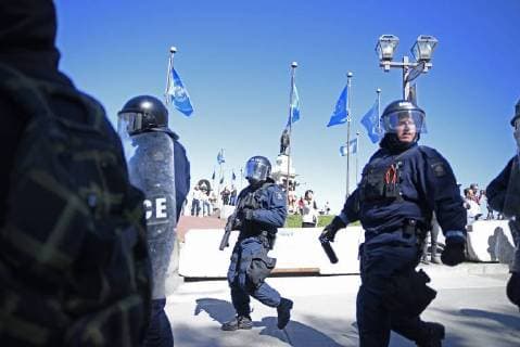 June 9, 2018 - Quebec City, Ontario, Canada - Riot police with pepper spray and tear gas gun following the people during a rally to protest the G7 summit in Quebec City, Canada on 9 June 2018. During the last day of the G7 summit that is happening in La Malbaie, Quebec, protesters came on to the streets to protest the summit in Quebec City. Quebec City Canada  - ZUMAn230 20180609_zaa_n230_1064 Copyright: xArindamxShivaanix