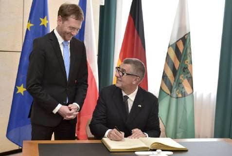Czech Prime Minister Andrej Babis (right) and Saxony Prime Minister Michael Kretschmer (left) take part in celebration of 25 years of Czech-Saxony cooperation in Dresden, Germany, on June 11, 2018. On the photo Babis signs a memorial book. (CTKxPhoto OndrejxHajek) CTKPhotoP201806110761601  HAJ 05