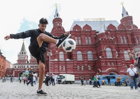 MOSCOW, RUSSIA - JUNE 13, 2018: A young man kicks Telstar 18, the official match ball of the 2018 FIFA World Cup in Russia, on the eve of the 2018 FIFA World Cup in Manezhnaya Square. Vyacheslav Prokofyev TASS  TS083DA6