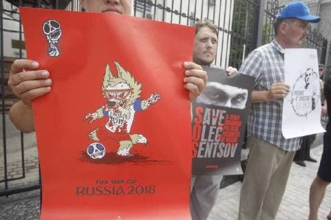 June 13, 2018 - Kiev, Ukraine - Ukrainian activists holds placards against the holding of the FIFA World Cup 2018 in Russia during a rally to support Ukrainian director Oleg Sentsov and other Ukrainian political prisoners in Russia, in front of the Embassy of Russia in Kiev, Ukraine, on 13 June 2018. Oleg Sentsov was sentenced by a Russian court on 25 August 2015 to 20 years in a high-security penal colony for terrorist attacks in Crimea annexed by Russia in April 2014. Kiev Ukraine - ZUMAg194 20180613_zap_g194_002 Copyright: xSergxGlovnyx