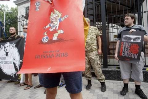 June 13, 2018 - Kiev, Ukraine - Ukrainian activists holds placards against the holding of the FIFA World Cup 2018 in Russia during a rally to support Ukrainian director Oleg Sentsov and other Ukrainian political prisoners in Russia, in front of the Embassy of Russia in Kiev, Ukraine, on 13 June 2018. Oleg Sentsov was sentenced by a Russian court on 25 August 2015 to 20 years in a high-security penal colony for terrorist attacks in Crimea annexed by Russia in April 2014. Kiev Ukraine - ZUMAg194 20180613_zap_g194_008 Copyright: xSergxGlovnyx