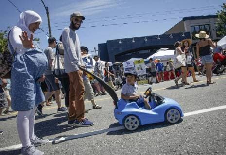 (180618) -- VANCOUVER, June 18, 2018 -- A child rides on his car-shaped stroller on the closed street during the Car Free Day event in Vancouver, Canada, June 17, 2018. The Car Free Day is an annual event to promote low carbon lifestyle and community engagement. More than 20 blocks of streets were closed from vehicle traffic that attracted people to enjoy different activities. )(gj) CANADA-VANCOUVER-CAR FREE DAY LiangxSen 