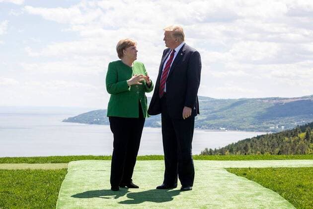 June 8, 2018 - Charlevoix, Quebec, Canada - U.S. President Donald Trump, right, chats with German Chancellor Angela Merkel during the G7 Summit at the gardens of the Fairmont Le Manoir Richelieu June 8, 2018 in Charlevoix, Quebec, Canada. Charlevoix Canada - ZUMAp138 20180608_zaa_p138_006 Copyright: xShealahxCraigheadx