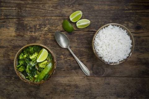 Green thai curry with broccoli, pak choi, snow peas, baby spinach, lime and bowl of rice  LVF06975