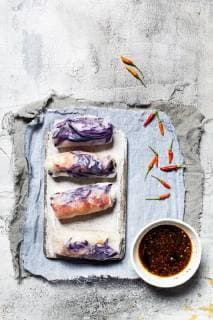 Vegan rice paper wraps (vietnamese summer rolls), filled with cabbage, carrots, bell pepper, rice noodles, and dipping sauce  SBDF03576