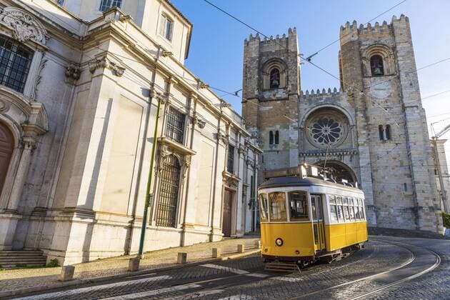 Portugal, Lisbon, typical yellow tram in front of the Cathedral  WPEF00216