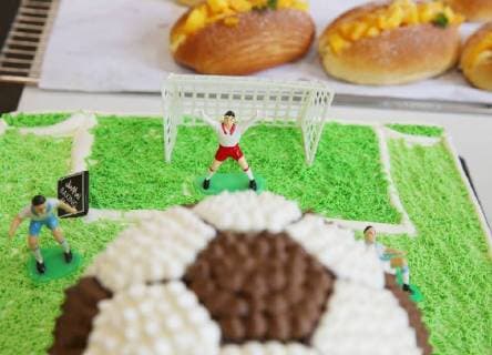 China: Football shaped cake Bakers make a World Cup themed cake at a bakery in Nantong, east China s Jiangsu Province. People can see football and football field at the cake. CHINA OUT Nantong Nantong China  XuxCongjun