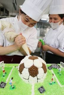 China: Football shaped cake Bakers make a World Cup themed cake at a bakery in Nantong, east China s Jiangsu Province. People can see football and football field at the cake. CHINA OUT Nantong Nantong China  XuxCongjun
