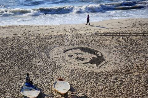 June 26, 2018 - Gaza City, Gaza Strip, Palestinian Territory - A Palestinian artist Osama Sbeata draws the portrait of Turkish President Recep Tayyip Erdogan on sand to celebrate the results of the Turkish presidential and parliamentary elections on Gaza Sea on June 26, 2018 Gaza City Palestinian Territory - ZUMAap3_ 20180626_zaf_ap3_054 Copyright: xAbedxAbuxRyashx
