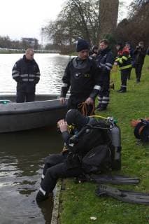 - BRUGGE, BELGIUM: Illustration picture shows divers and a boat searching for Frederic Coopman, Tuesday 13 December 2011 in the Ringvaart river in Brugge. 20 year old student Coopman has been missing since he left a party on Saturday, his gray woolen hat and one of his black gloves were found at the Gentpoort in Brugge. KURTxDESPLENTER x31604015x