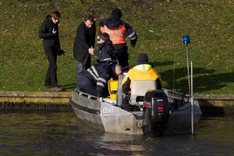 - BRUGGE, BELGIUM: Illustration picture shows divers and police during the search for Frederic Coopman, Tuesday 13 December 2011 in the Ringvaart river in Brugge. 20 year old student Coopman has been missing since he left a party on Saturday, his gray woolen hat and one of his black gloves were found at the Gentpoort in Brugge. KURTxDESPLENTER x31604183x