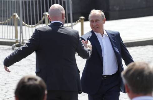 MOSCOW, RUSSIA - JUNE 28, 2018: FIFA President Gianni Infantino (L) and Russia s President Vladimir Putin shake hands as they visit the 2018 FIFA World Cup Football Park in Red Square. Mikhail Metzel TASS  TS086D46