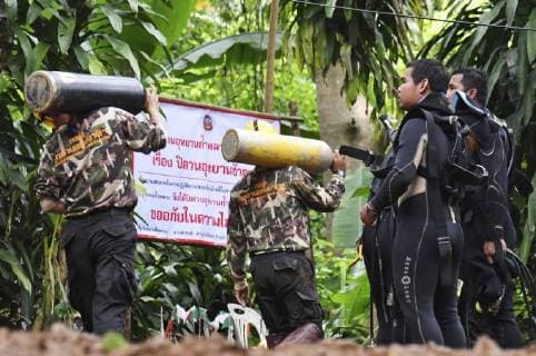 Boys, football coach missing in Thai cave Divers carrying equipment enter the Tham Luang Nang Non cave complex in northern Thailand on July 2, 2018, where 12 boys and their soccer coach are believed to be trapped. 