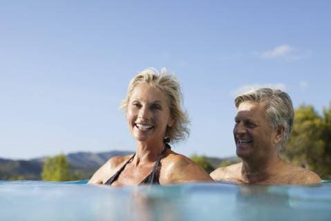 Mature couple relaxing together in pool  Copyright: AntoinexArraou B94586713