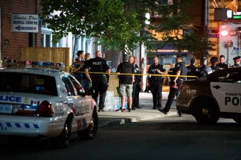 (180723) -- TORONTO, July 23, 2018 -- Police officers gather at the crime scene in Toronto, Canada, on July 23, 2018. A man shot 14 people, killing one and injuring 13 others in Toronto s east-end neighborhood before dying after an exchange of gunfire with police, according to CTV Monday. ) (dtf) CANADA-TORONTO-SHOOTING LixHaitao 