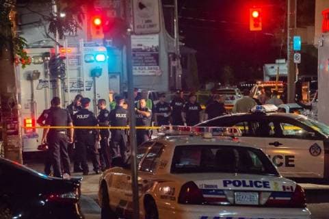July 23, 2018 - Toronto, Ontario, Canada - Police on the scene of a mass shooting after as many as 15 people have been shot, three have died, after a gunman opened fire on Danforth Avenue West of Logan Avenue Sunday evening shortly after 10 PM on July 22, 2018. Toronto Canada - ZUMAb167 20180723_zap_b167_008 Copyright: xVictorxBirox