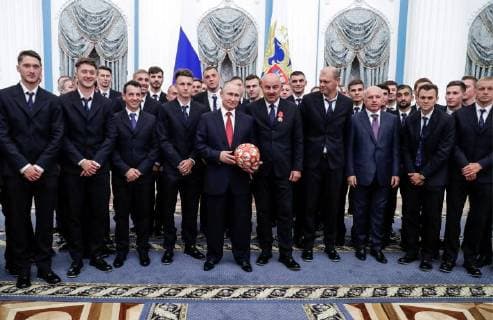 MOSCOW, RUSSIA - JULY 28, 2018: Football players Alexei Miranchuk, Anton Miranchuk, coach of Russia s national men s football team Pulino Granero, football player Alexander Golovin, the President of Russia Vladimir Putin, the head coach of Russia s national team Stanislav Cherchesov, and coach of Russian s national football team Miroslav Romashchenko (from L front), and Russian football players and sports officials pose with a ball for a photograph after a ceremony to award national decorations to Russia s national men s football team and coaches at the Kremlin; the Russian national team reached the quarterfinals at the 2018 FIFA World Cup. Mikhail Metzel TASS  TS08B0C2