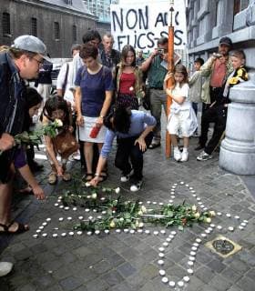 BRU13 - - LIEGE, BELGIUM: Anti-globalisation demonstrators commemorate in front of the Italian consulate in Liege the death of Italian demonstrator Carlo Giuliani who was killed by an Italian policeman during clashes at the last G8 top in Genoa, Monday 20 August 2001. GUYxMOSSAY  x726162x