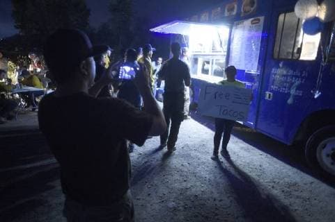 August 6, 2018 - Ukiah, California, USA - Ukiah, California, U.S. - Members of St Marys of Angels Catholic Church in Ukiah greet fire fighters as they return to base camp and offer them a free meal of tacos. Ukiah USA - ZUMAw332 20180806_zap_w332_012 Copyright: xNealxWatersx