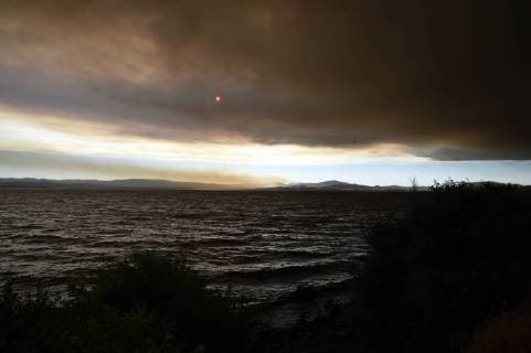 August 6, 2018 - Ukiah, California, USA - Ukiah, California, U.S. - The sun begins to set through the smoke from the Ranch Fire at the northern end of Clear Lake. Ukiah USA - ZUMAw332 20180806_zap_w332_005 Copyright: xNealxWatersx