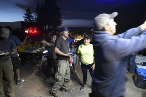 August 6, 2018 - Ukiah, California, USA - Ukiah, California, U.S. - Members of St Marys of Angels Catholic Church in Ukiah greet fire fighters as they return to base camp and offer them a free meal of tacos. Ukiah USA - ZUMAw332 20180806_zap_w332_010 Copyright: xNealxWatersx