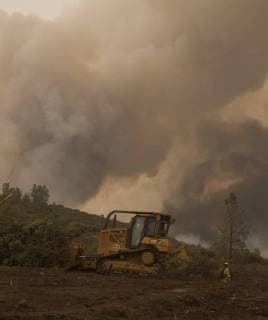 CalFire personnel use a bulldozer to create a fire break along a ridge in Colusa County, California on August 7, 2018. The Mendocino Complex fire has become the largest in the state s history.  SXP2018080703 TERRYxSCHMITT