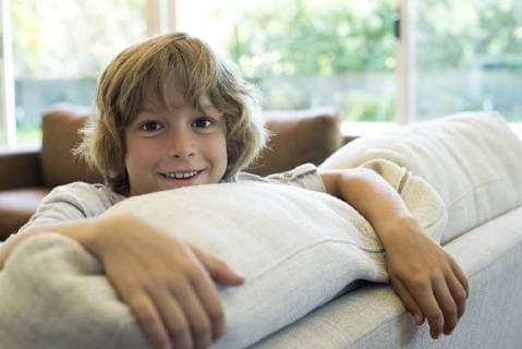 Boy leaning on sofa  Copyright: EricxAudras B03040419
