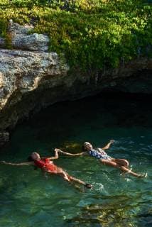 Young women floating on water in lagoon model released Symbolfoto  BEF00170