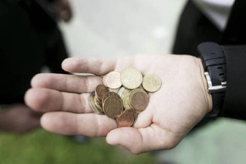 Euro coins in the hand of a businessman model released Symbolfoto  KMKF00382