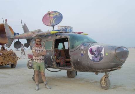 August 25, 2018 - Black Rock, NV, United States of America - A burner poses next to his art car on the playa during the annual Burning Man counter culture festival in the desert August 25, 2018 near Black Rock, Nevada. Each year 80,000 of people set up a temporary art city in the middle of the desert. Black Rock United States of America - ZUMAp138 20180825_zaa_p138_001 Copyright: xBlmx
