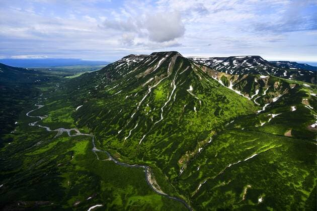KAMCHATKA TERRITORY, RUSSIA - AUGUST 23, 2018: The Vostochny Mountain Ridge on Kamchatka Peninsula on Russia s Pacific coast, at dusk. Yuri Smityuk TASS  TS08DF58