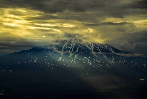 KAMCHATKA TERRITORY, RUSSIA - AUGUST 23, 2018: Clouds over Kronotskaya Sopka (Kronotsky) Volcano on Kamchatka Peninsula on Russia s Pacific coast, at dusk. Yuri Smityuk TASS  TS08DF59